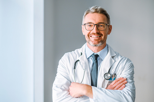 A happy male medical doctor looking at the camera with copy space. Portrait of a healthcare professional with a bright smile and copyspace. An organized GP with a satisfying career at the hospital