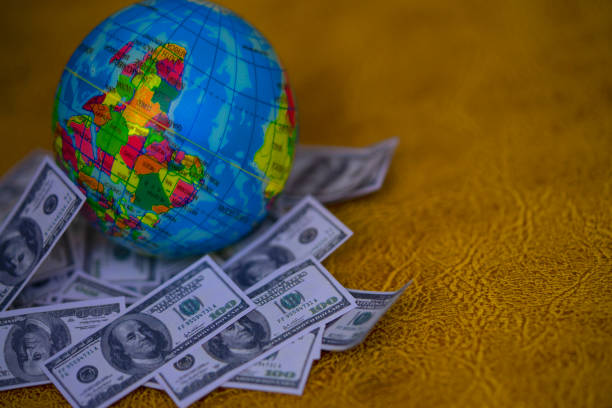 istock Artificial American Dollas and  earth model for background 1411624893