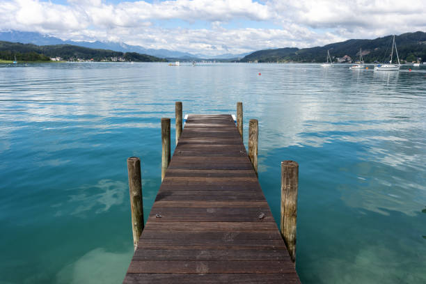 Dock at the Woerthersee in Carinthia, Austria Dock at the Woerthersee in Carinthia, Austria pörtschach am wörthersee stock pictures, royalty-free photos & images