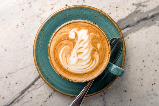coffee cappuccino with beautiful pattern on marble table top view