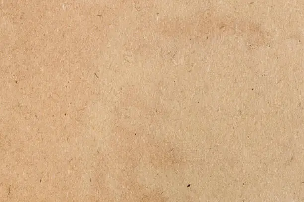 paper background - surface of vintage shabby brown cardboard close up