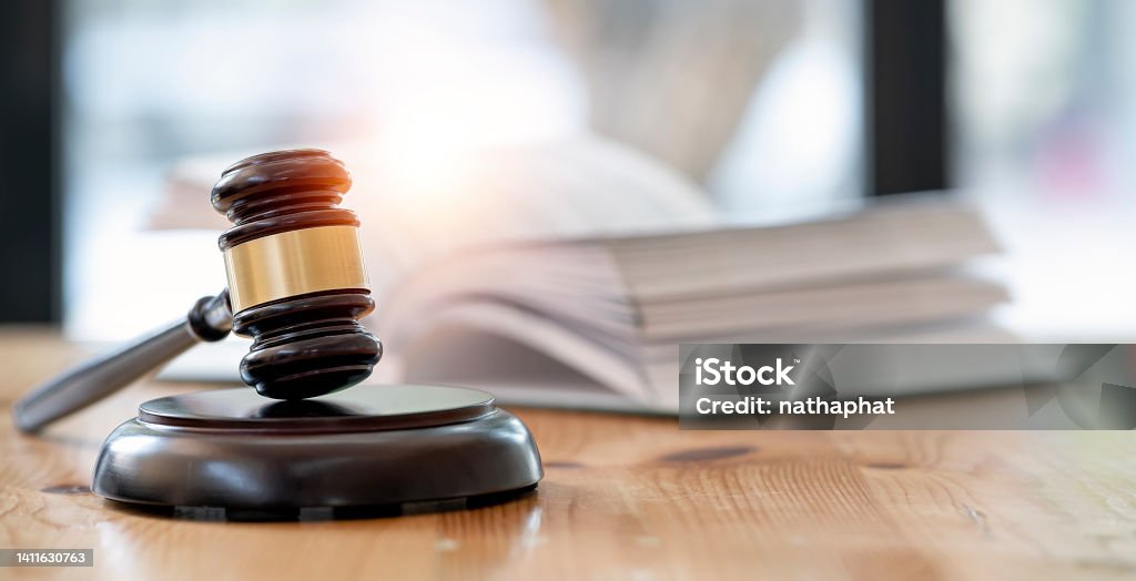 Wooden brown judge gavel on the table, copy space, banner background. Legal System Stock Photo