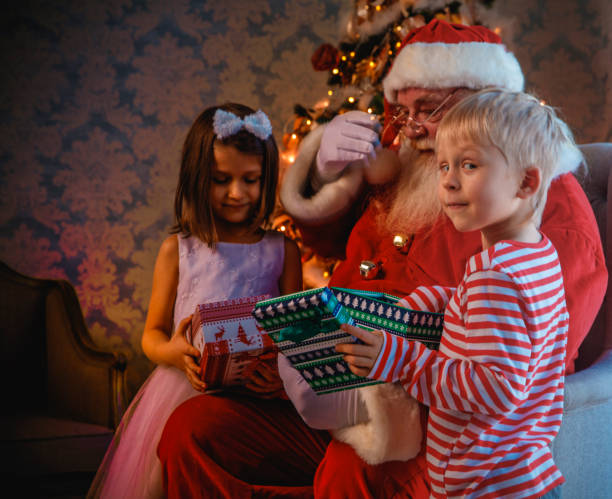istock Santa Claus gives presents 1411632492