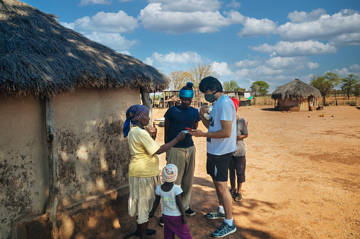 ngo people teaching mobile payments in rural africa, village in Botswana