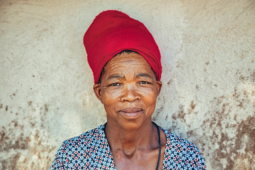 portrait of an african woman with an red scarf village in Botswana