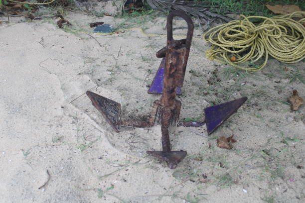istock Rustic anchor of boat ship on seashore 1411634344