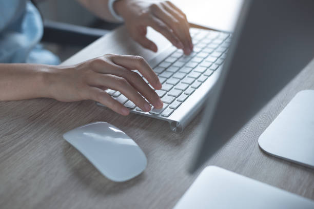 istock Close up, woman hands typing, working on desktop computer keyboard with digital tablet and mobile phone on table at home office 1411634501
