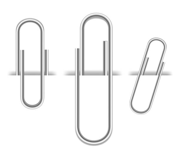 istock Set of realistic metal paper clips isolated on white background. Page holder, binder. Vector illustration. 1411635051