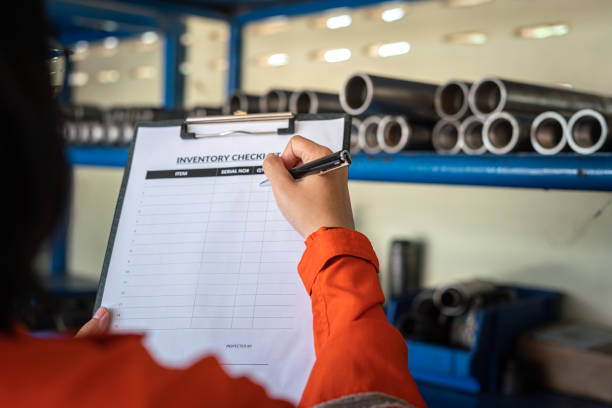 istock Checking on the inventory checklist form - Industrial working action. 1411636123