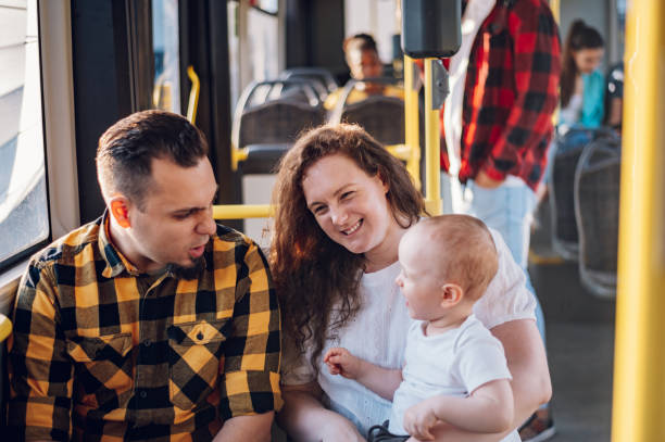 istock Parents riding a bus with their child during a day. 1411636516