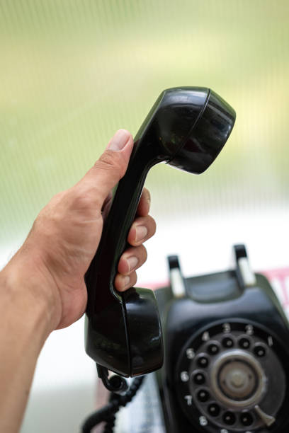 istock Using an antique analog  telephone. 1411636630