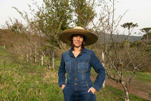 Woman on an organic farm standing by the cherry trees