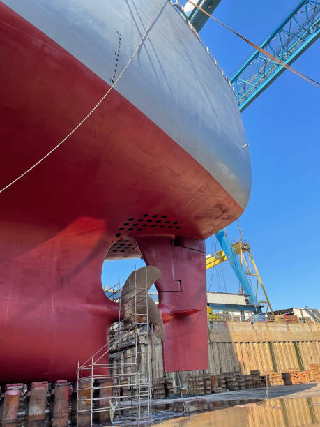 istock Dry-cargo ship in dry dock for repairs and maintenance at a shipyard. 1411639759