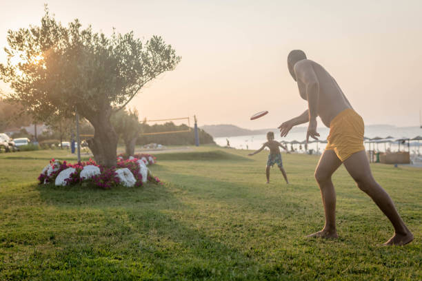 istock Playing frisbee with my dad at sea during sunset 1411640051
