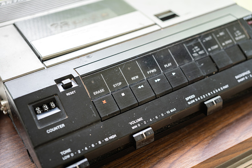 A classics style analog cassette player or sound recording device. Technology and equipment object photo.