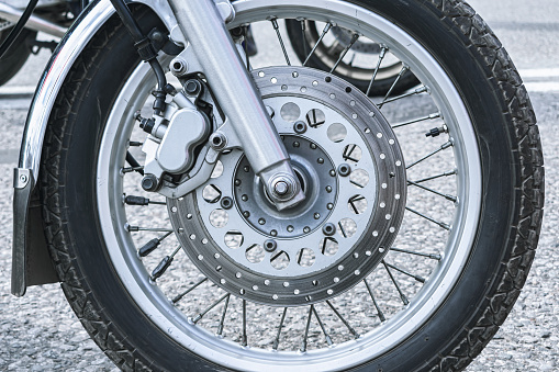 Close-up of the front wheel of a motorcycle and its mechanics