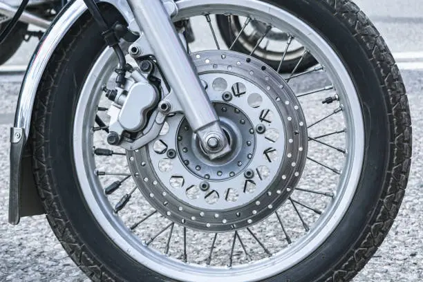 Photo of Close-up of the front wheel of a motorcycle