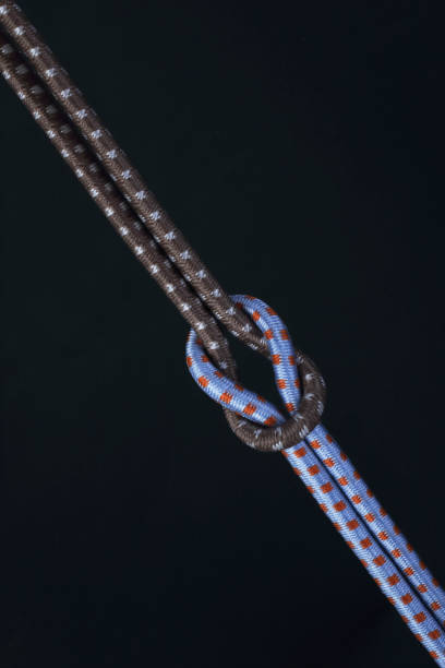 Colored ropes tied in a knot on a black background