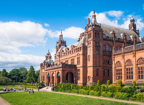 Glasgow, Scotland - People enjoying sunny weather outside the main entrance to the Kelvingrove Art Gallery and Museum.