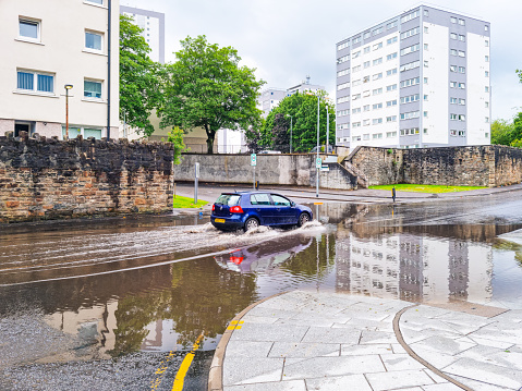 The street in New York is flooded with rainwater because of the torrential rain and storm.