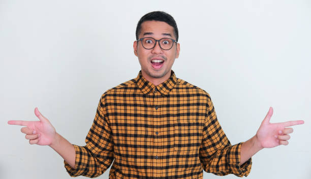 istock Adult Asian man showing amazed expression while pointing to the left and right side 1411644766