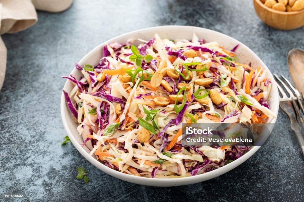 Asian cabbage cole slaw with peanut sauce Asian cabbage cole slaw with peanut sauce, roasted peanuts and green onions Coleslaw Stock Photo