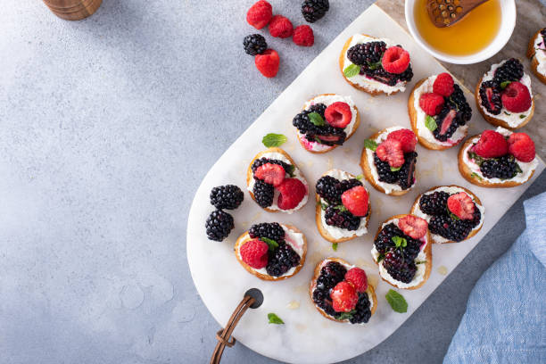 istock Berry and goat cheese bruschetta with mint and honey 1411646662