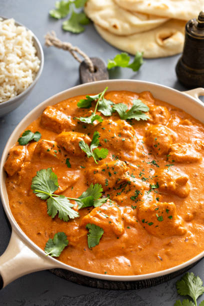 istock Chicken tikka masala, cooked marinated chicken in spiced curry sauce 1411646706