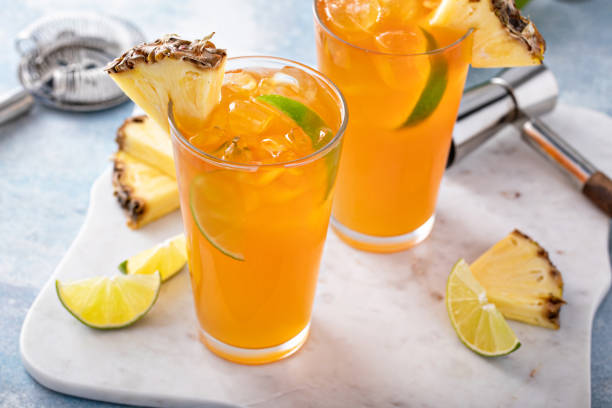 istock Pineapple rum cocktail with lime slices, refreshing summer cocktail 1411646768