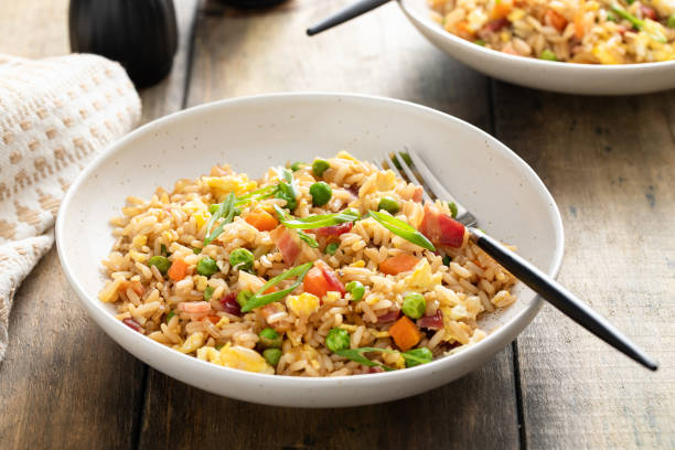 Breakfast fried rice with bacon and scrambled eggs Breakfast fried rice with bacon, carrots, peas, green onions and scrambled eggs fried rice stock pictures, royalty-free photos & images