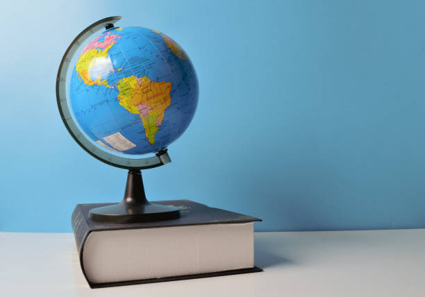 istock Earth globe and book on the table. Copy space for the text. 1411646784