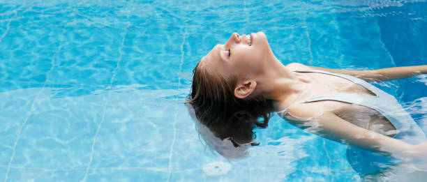 istock Young woman in the pool. 1411646952