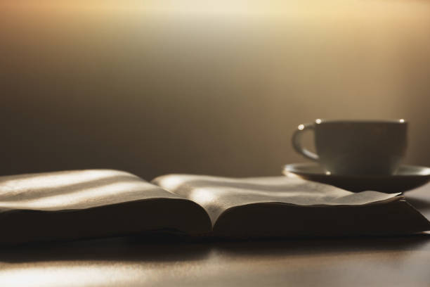 morning bible study Open the Bible in the morning for prayer with a cup of coffee on a wooden table.  with the morning sun shining through the window christian democratic union photos stock pictures, royalty-free photos & images
