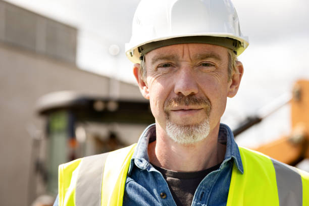 istock Mature men civil engineer supervises outdoor construction work 1411651766