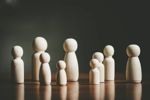 istock Wooden figures representing a group of people, teamwork concept. 1411652706