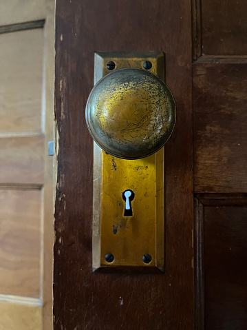Old vintage brass doorknob with keyhole straight close-up