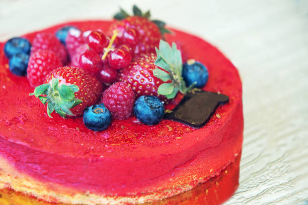 istock Fantastic Cake in Paris   ( on show case)  with fruit  topping: strawberries raspberries blueberries and red currants 1411658699