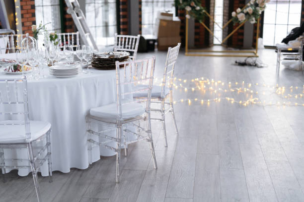 istock Transparent plastic chairs for wedding guests. Modern loft space, large windows. 1411660197