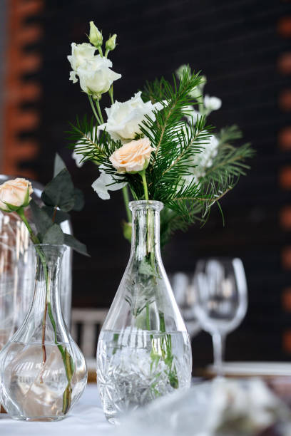 istock Beautifully served wedding table decorated with designer vases with bouquets. 1411660228