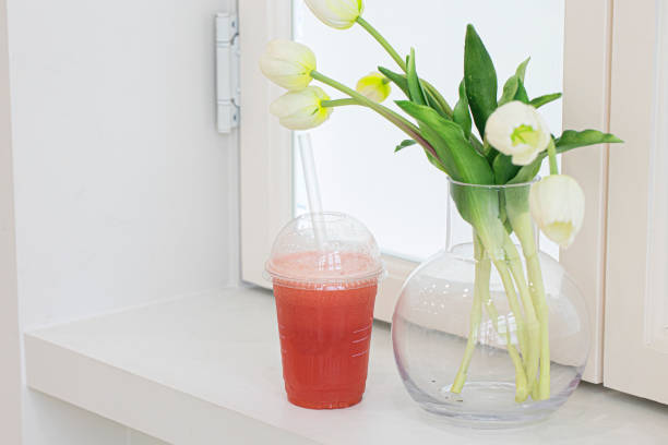 istock Watermelon smoothie in plastic cup isolated 1411661789