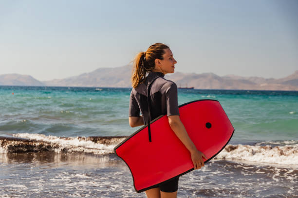 istock Confident female surfer on the beach 1411661984