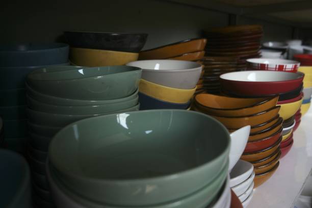 istock Stacks of colors porcelain bowls displayed on rack. 1411663914