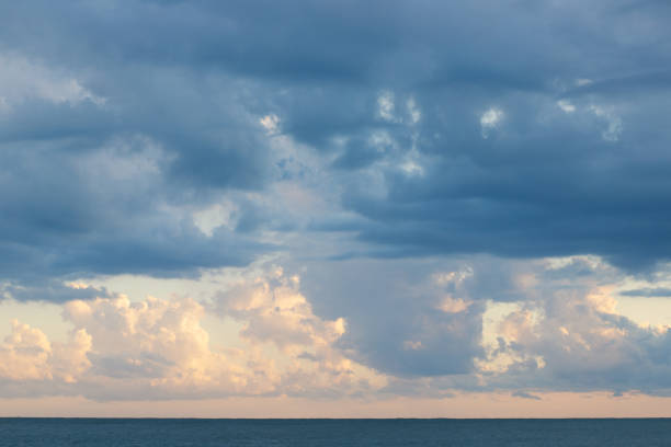 istock cloudy sky on the sea in sunlight,clouds background at sunset 1411668777