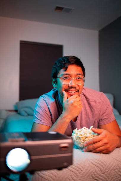 (Interested) Man Watching a Movie in Bed with Projector