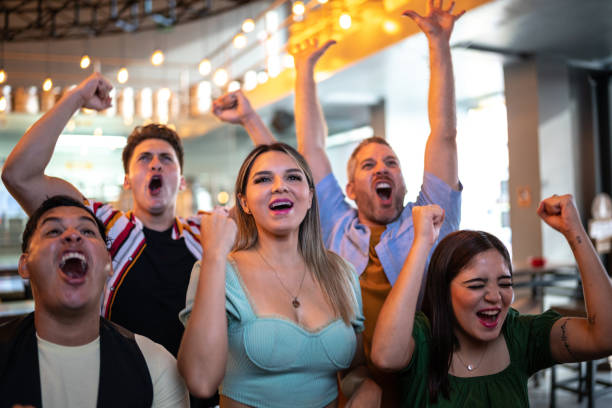 istock Friends watching and celebrating a sport match 1411670905
