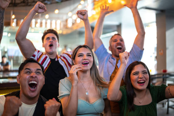istock Friends watching and celebrating a sport match 1411671027