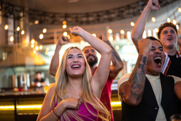 istock Friends watching and celebrating a sport match 1411671030