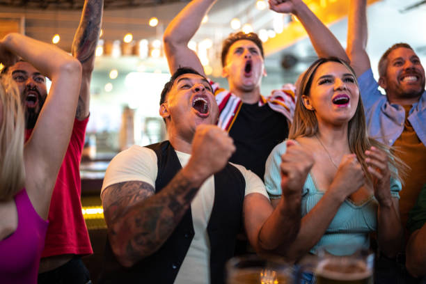 istock Friends watching and celebrating a sport match 1411671031