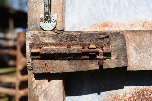 old rusty latch on the wooden door .corrosion of steel