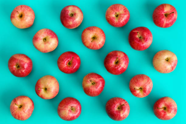 istock Fruit pattern of red apple on blue background. Flat lay, top view. Pop art design, creative summer concept. Food background. 1411675404